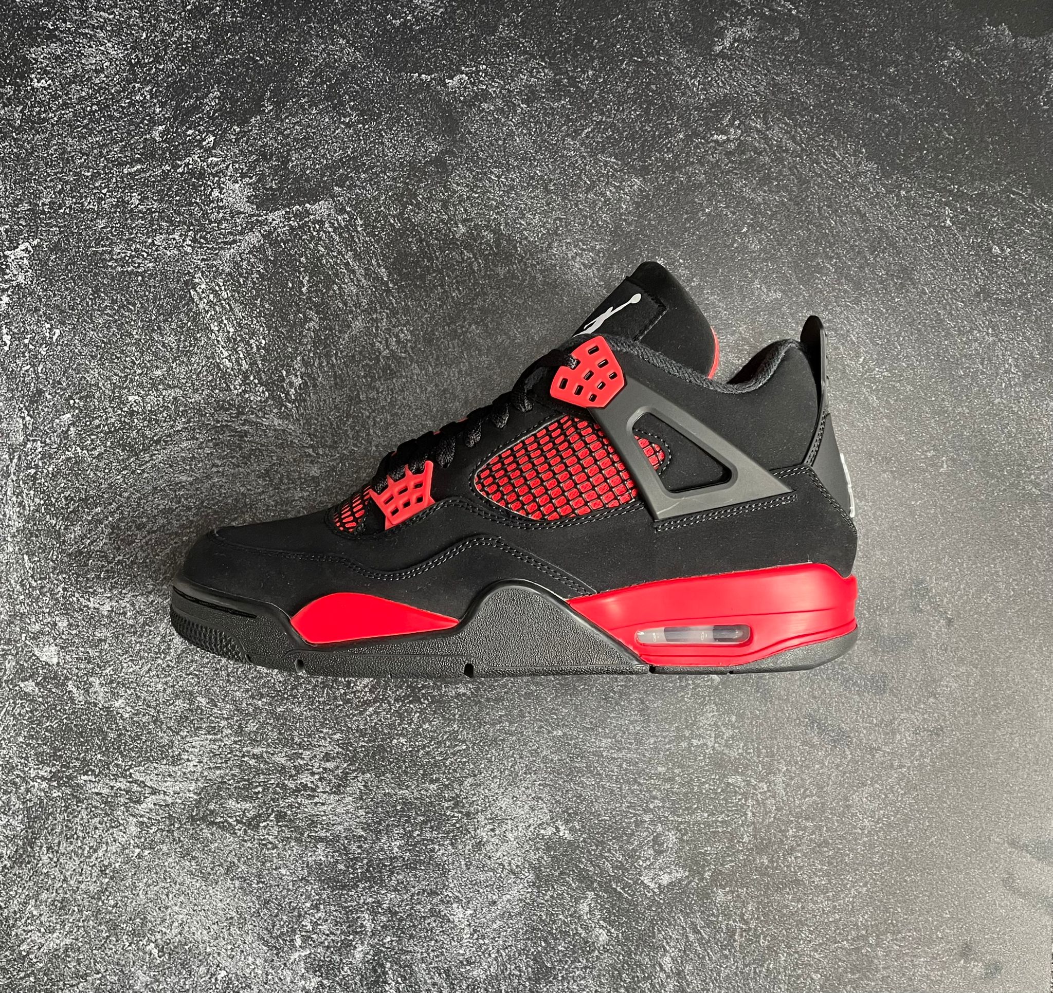 Air Jordan 4 Thunder Red colourway side view with visible Air unit