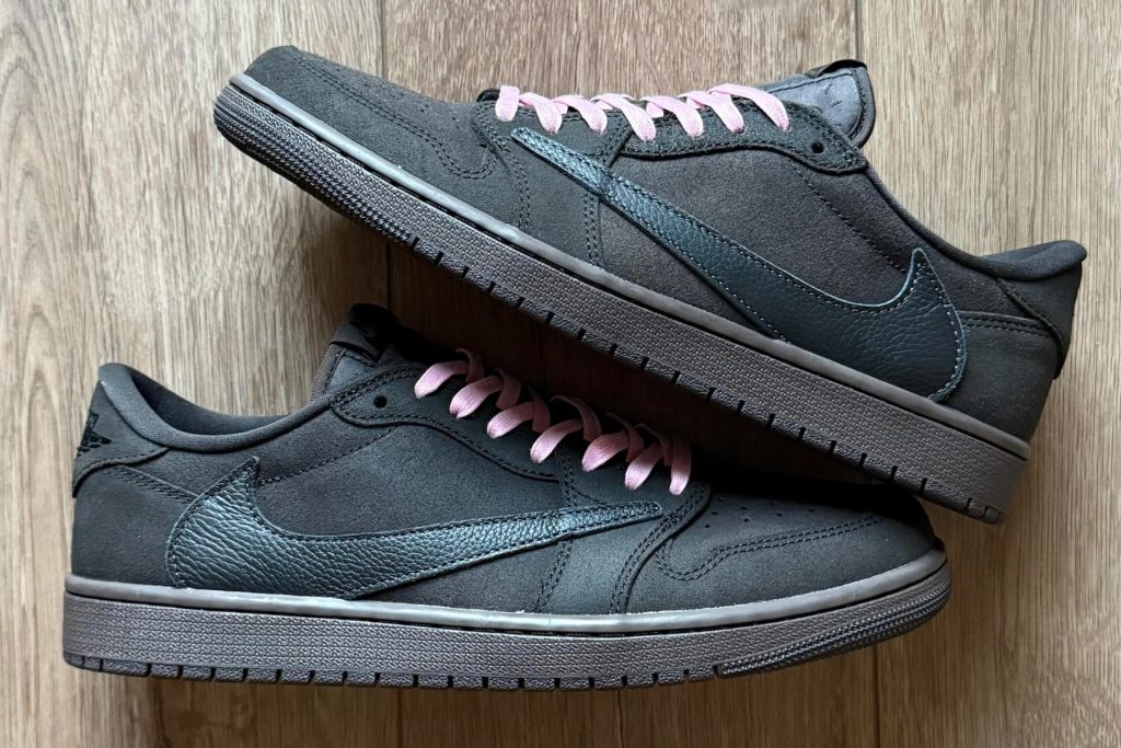 Side view of stacked Jordan 1 Low Travis Scott Velvet Brown with pink laces highlighting suede upper